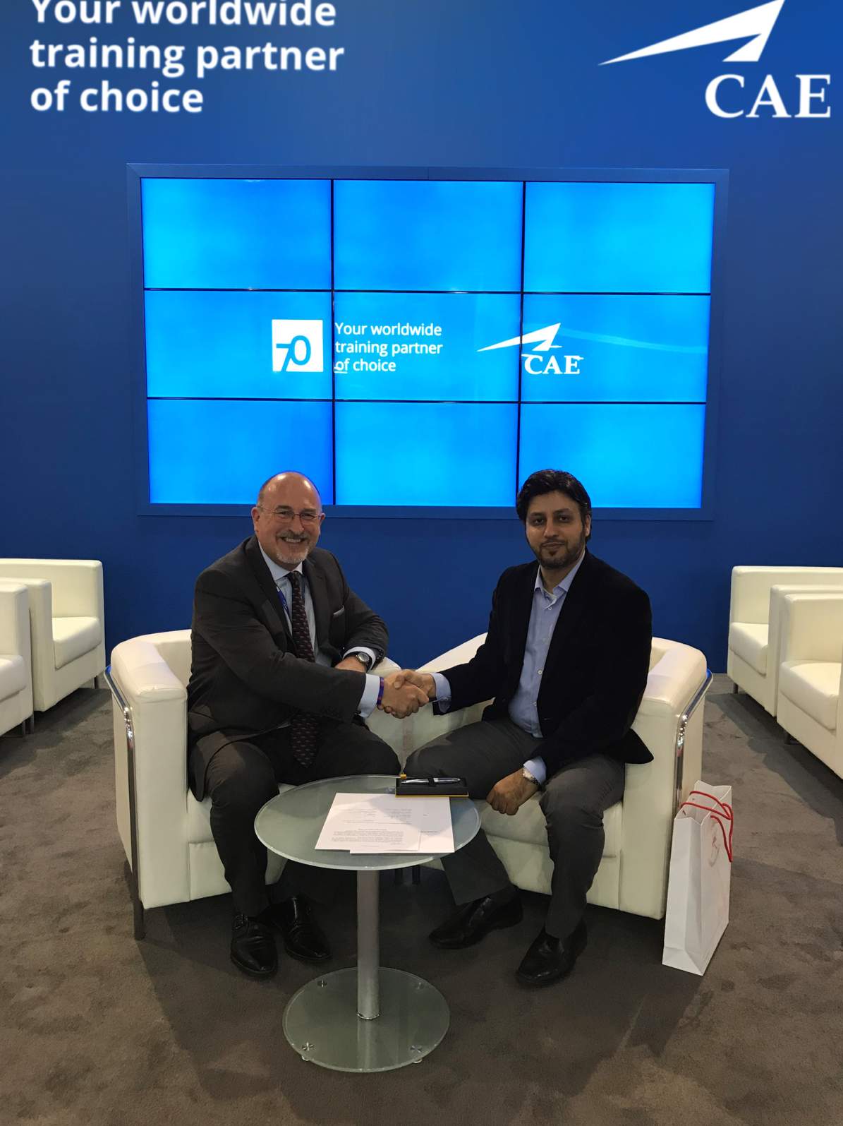 Ian Bell, CAE (left) and Dr. Dhafir Awadh Al Shanfari, OAPFD (right) celebrate the signing of an agr